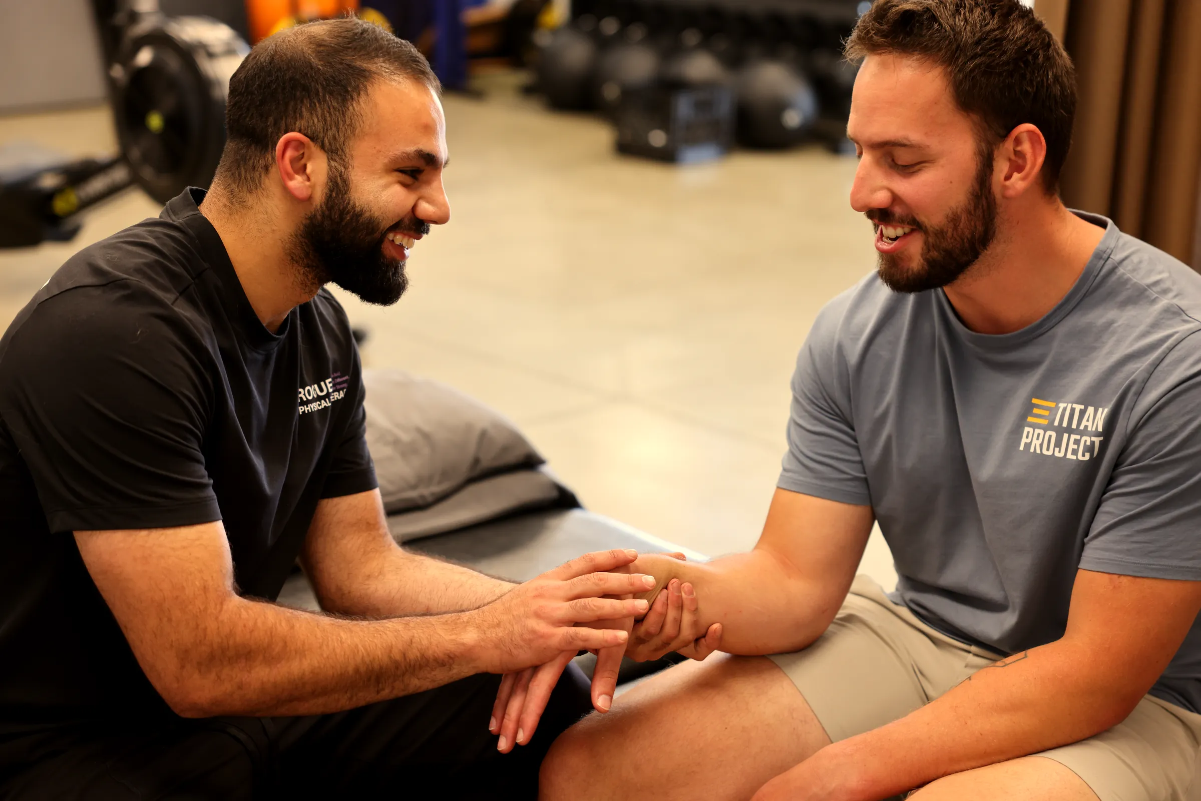 Physiotherapist and patient sitting face to face in conversation at the clinic.
